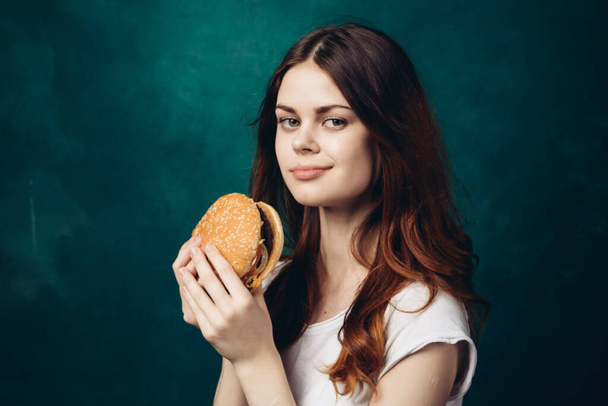cheerful woman eating hamburger snack close-up lifestyle - Foto, Bild