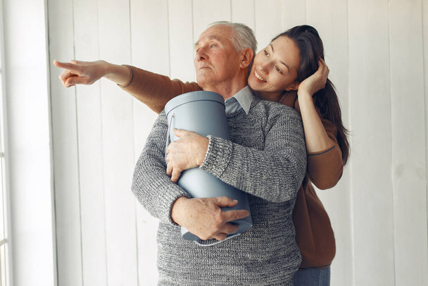 Elegant old man standing at home with his granddaughter - Foto, Imagem