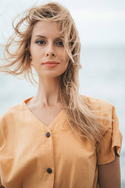 A portrait of caucasian blonde woman at the beach - Fotó, kép