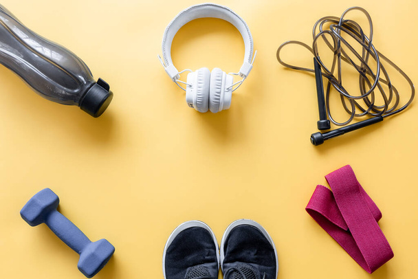 Flat lay composition with sports equipment on yellow background. - Photo, Image