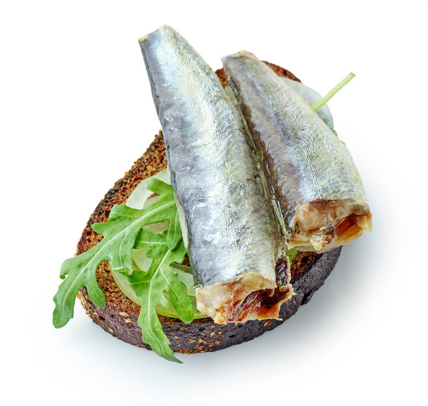 Sardinen in Dosen auf Brotscheibe isoliert auf weißem Hintergrund, Ansicht von oben - Foto, Bild