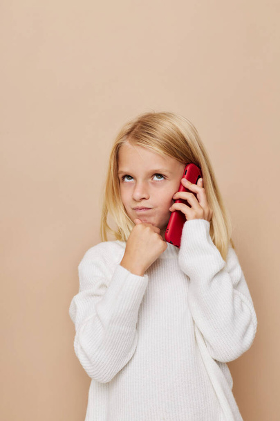 Beautiful little girl communication smartphone entertainment posing studio - Foto, Imagem