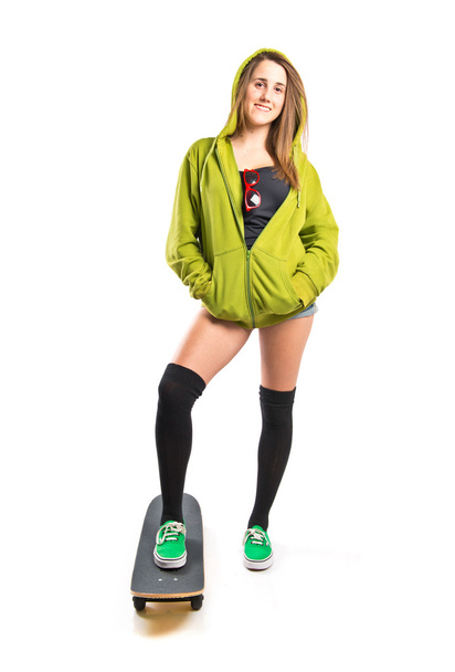 Skater with green sweatshirt over white background - Foto, afbeelding