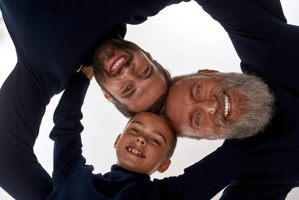 Portrait of three generations of men hug show support - Foto, Imagen