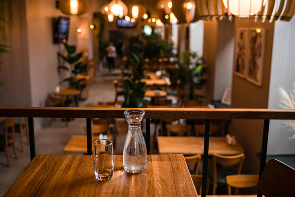 Beautiful interior restaurant with wooden tables and chairs. interior of the restaurant cafe table close-up, Soft focus. Shallow DOF - Fotó, kép