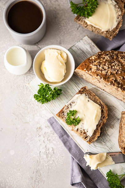 Freshly baked artisan multigrain bread with butter and pate. Breakfast with coffee, sliced bread, butter and liver pate. - 写真・画像