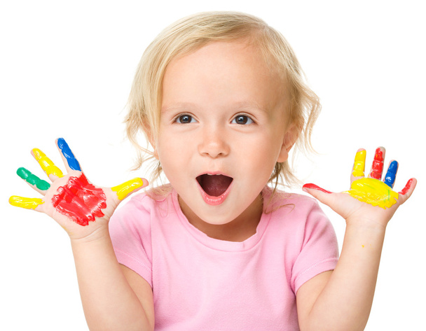 Portrait of a cute little girl playing with paints - Фото, изображение