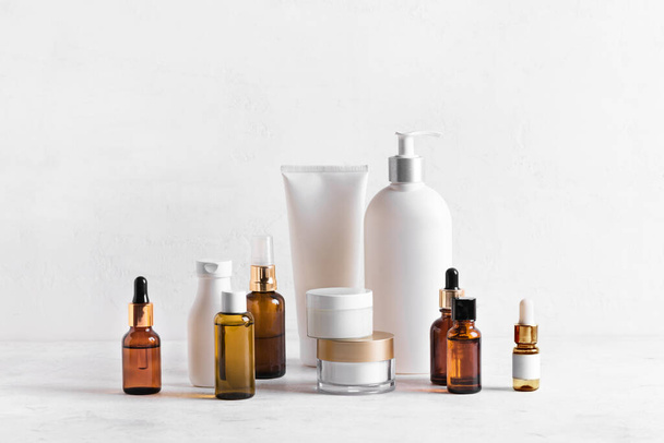 Skincare Beauty Products on white table, assortment of cosmetics bottles, healthy cosmetology, spa treatment concept, copy space. - Photo, image