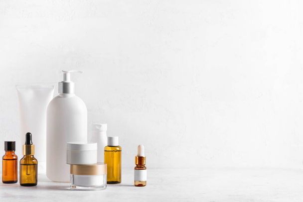 Skincare Beauty Products on white table, assortment of cosmetics bottles, healthy cosmetology, spa treatment concept, copy space. - 写真・画像