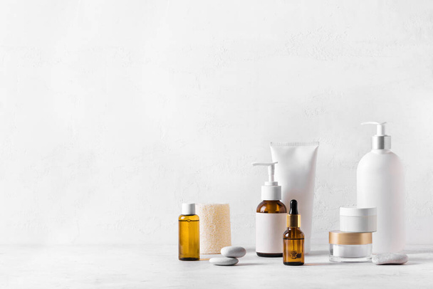 Skincare Beauty Products on white table, assortment of cosmetics bottles, healthy cosmetology, spa treatment concept, copy space. - Fotografie, Obrázek
