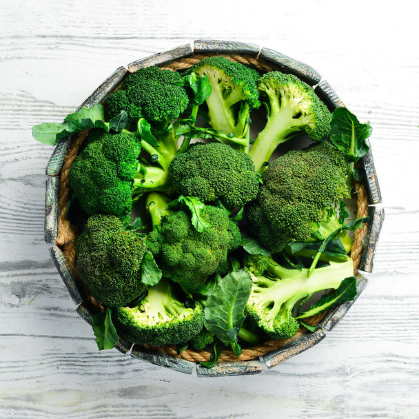 Vegetables. Fresh green broccoli on a white wooden background. Rustic style. Top view. - Foto, imagen