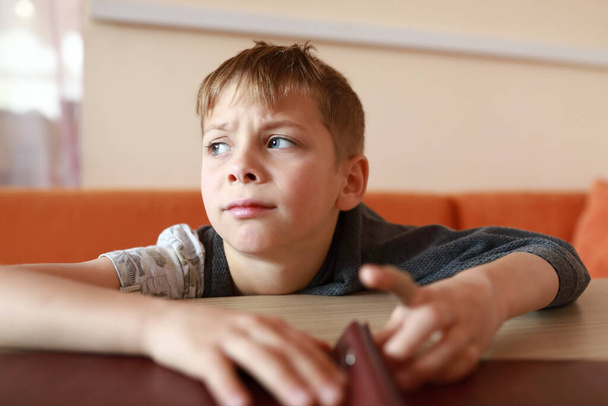 Upset hungry child waiting food in restaurant - Photo, image