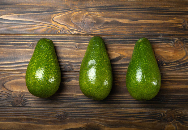 Close-up of an avocado on a wooden background. Healthy food concept. - Fotografie, Obrázek