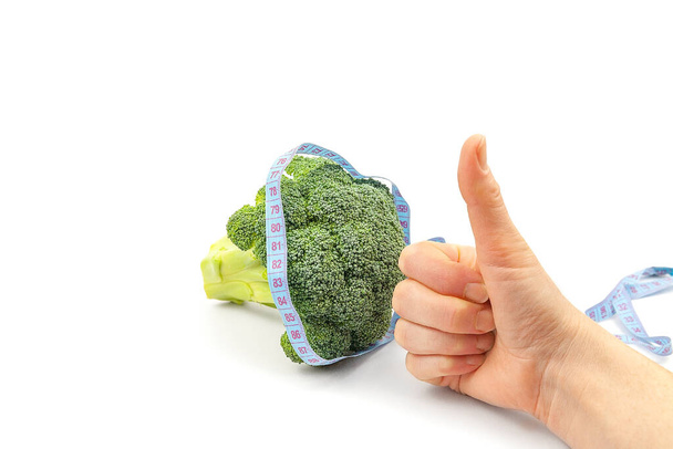 Woman's hand holding brocoli on white background. vegetarianism. healthy eating - Fotó, kép