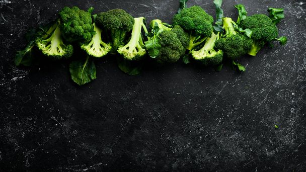 Broccoli. Fresh green broccoli on a black stone table. Top view. Free copy space. - Foto, afbeelding