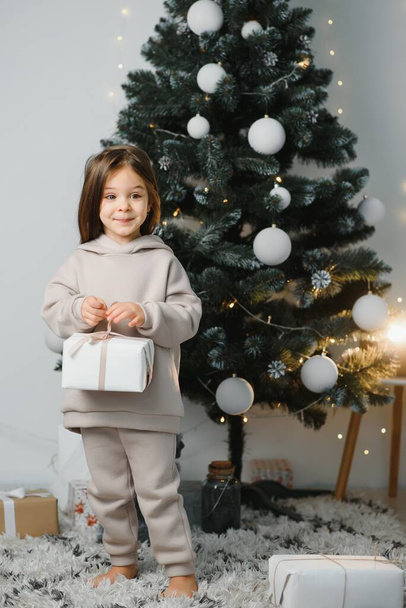 Little cute girl near christmas tree - 写真・画像