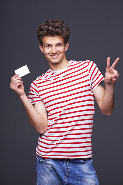 Man showing empty blank paper card sign - Photo, image