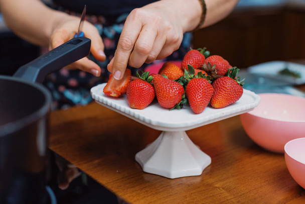A woman making a dessert with strawberries - Φωτογραφία, εικόνα