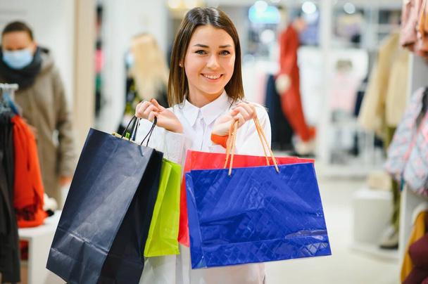 Γυναίκα στα ψώνια. Ευτυχισμένη γυναίκα με τσάντες για ψώνια που απολαμβάνει στα ψώνια. Καταναλωτισμός, ψώνια, τρόπος ζωής - Φωτογραφία, εικόνα