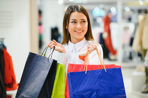 Woman in shopping. Happy woman with shopping bags enjoying in shopping. Consumerism, shopping, lifestyle concept - Φωτογραφία, εικόνα