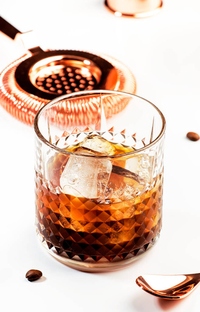 Black russian cocktail, trendy alcoholic drink with vodka, coffee liqueur and ice, white background, bar tools - Fotografie, Obrázek
