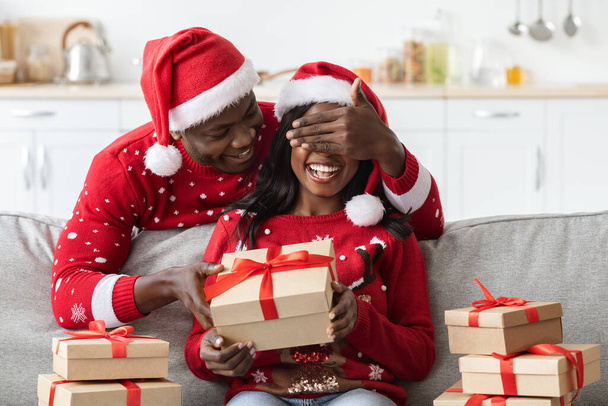 Loving black man making surprise for girlfriend on Christmas - Photo, Image