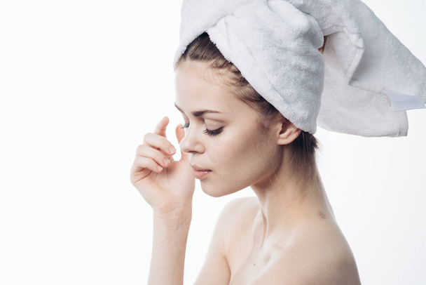 woman after shower with towel on head posing skin care - Foto, afbeelding