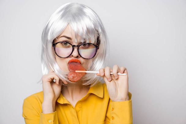 cheerful glamorous woman with a lollipop in her hands model - Φωτογραφία, εικόνα