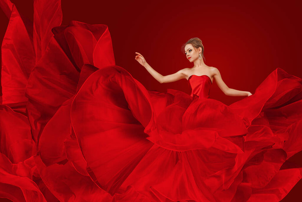 Young Woman in Red Silk Dress, Flying Fabric, Long Gown Waving Fluttering on Wind - Foto, immagini