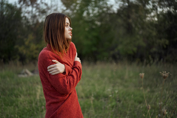 woman in a red sweater outdoors in the field nature rest - Foto, Imagen