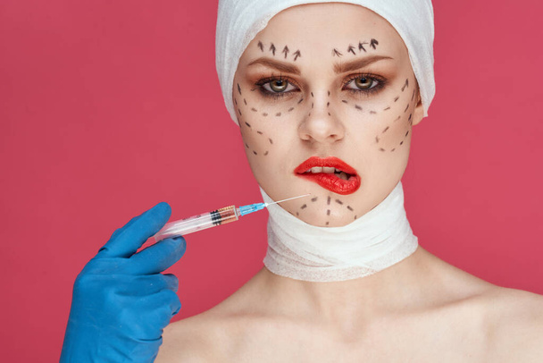a person posing in blue gloves red lips surgery facial rejuvenation studio lifestyle - Фото, зображення