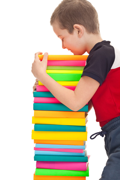 School kid holds a stack of books - Zdjęcie, obraz