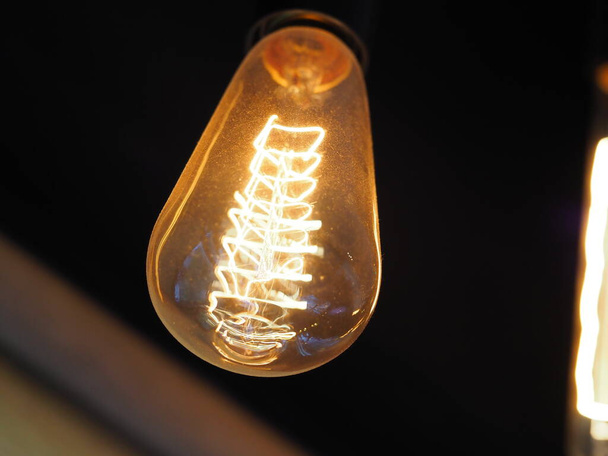 old vintage type incandescent light bulbs shine in the interior of the studio - Photo, Image