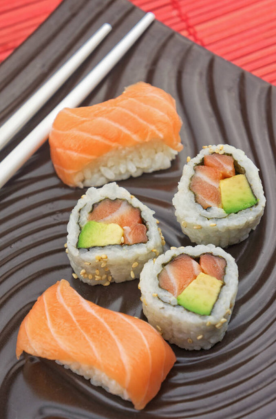 Japanese seafood sushi with chopsticks on a white background - Photo, image