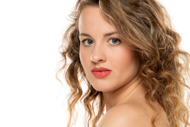 portrait of a blonde young woman with blue eyes and curly hair on a white background - Foto, imagen
