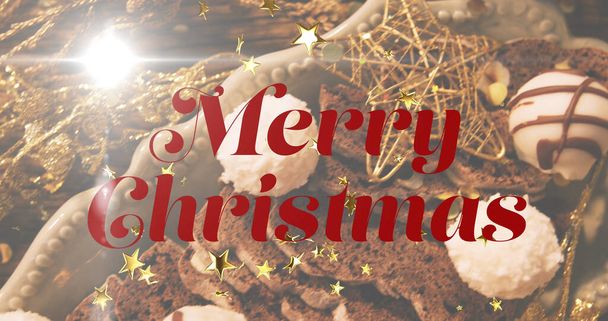 Image of merry christmas text over christmas decoration. christmas, tradition and celebration concept digitally generated image. - Foto, Imagen