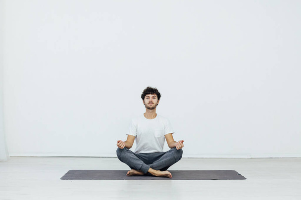 a man doing gymnastics yoga asana in a room - Photo, Image