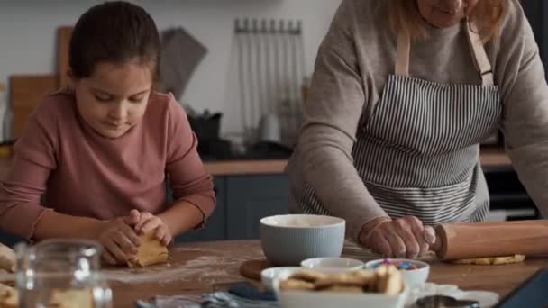 Caucasian girl baking cookies with grandmother. Shot with RED helium camera in 8K    - Footage, Video