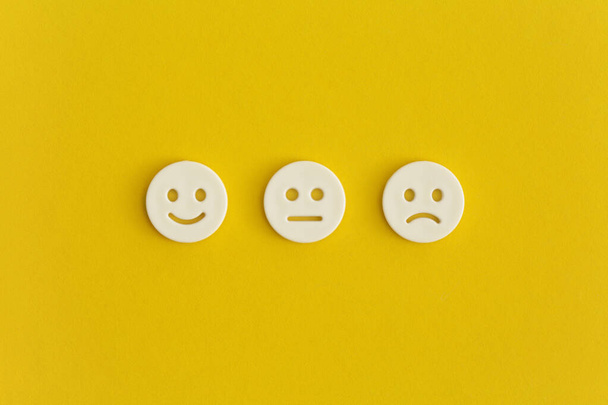 Emoticon smile on a yellow background. Customer feedback. - Photo, image