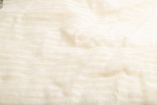 Fragment of smooth white linen tissue. Side view, natural textile background and texture. - Zdjęcie, obraz