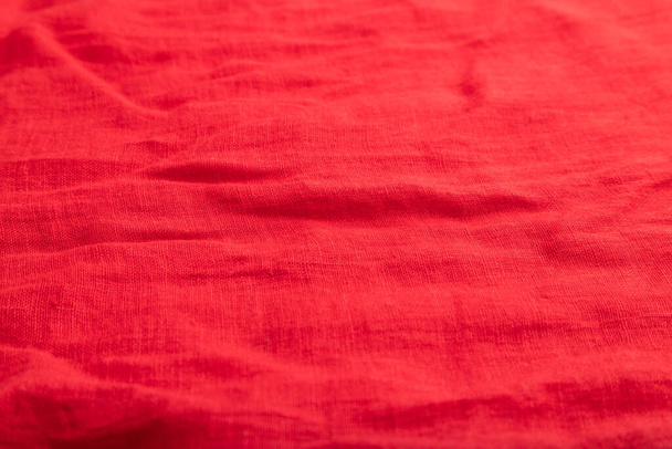 Fragment of smooth red linen tissue. Top view, flat lay, natural textile background and texture. - Photo, Image