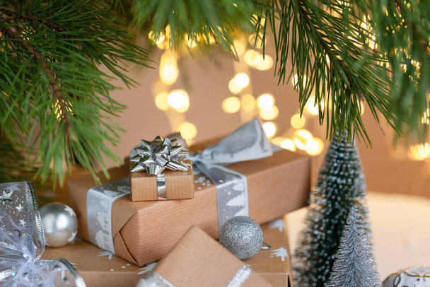 Festive zero waste gift boxes under Christmas tree in the home interior of the living room. Preparation of gifts to relatives. New year holiday cozy, mood festive concept. - Fotoğraf, Görsel