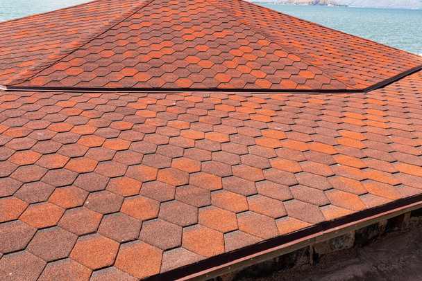 Flexible ruberoid shingles or bitumen tile. Modern roofing material concept - Photo, Image