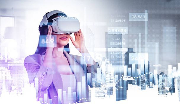 Businesswoman in formal wear is wearing vr helmet. Singapore and New York city skyscraper financial downtown center and office workplace in the background with bar diagram. Concept of virtual reality - Photo, Image