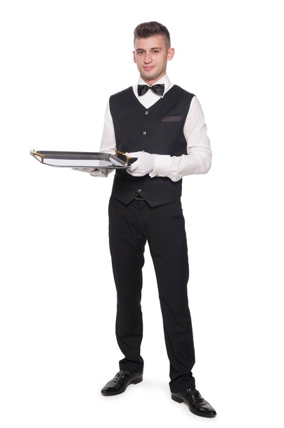 ένα νεαρό αγόρι σερβιτόρος με ένα δίσκο - Φωτογραφία, εικόνα
