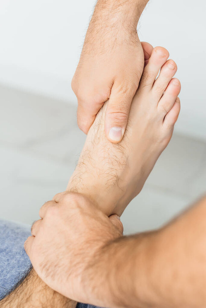 Osteopath working with ankle, close-up - Zdjęcie, obraz