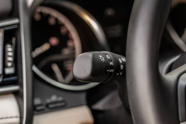 Light switch control. Close up of car light switch and control. Modern car interior detail. - Foto, afbeelding