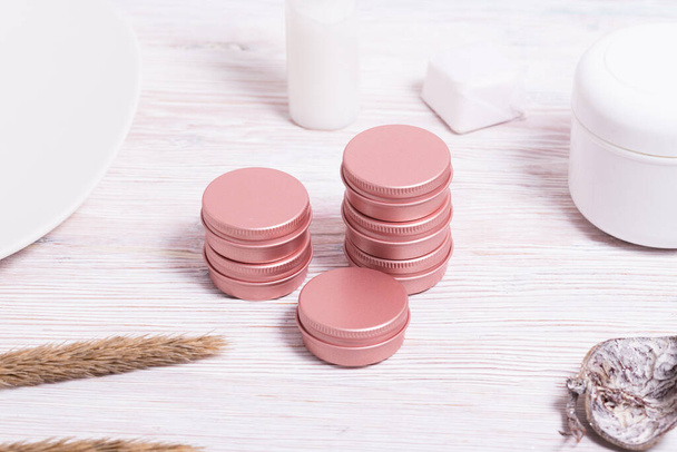 Set of small tin metal cases for cosmetic on wooden table   - Foto, immagini
