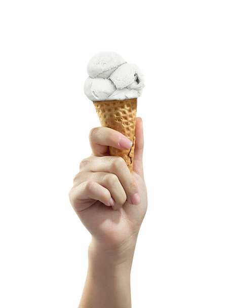 A woman hand holding Ice cream scoop on cone - Fotó, kép