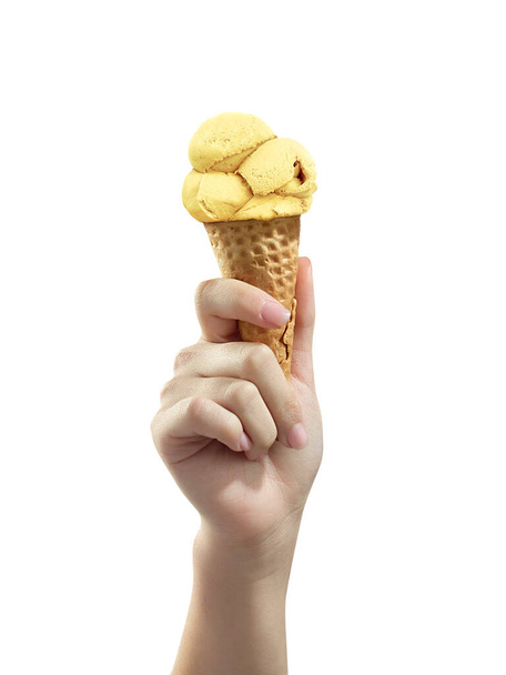 A woman hand holding vanilla Ice cream scoop on cone - Foto, afbeelding